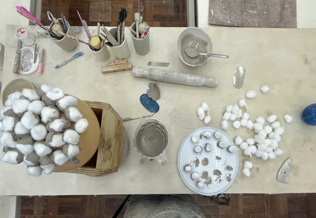 Table with cotton balls and various ceramic tools